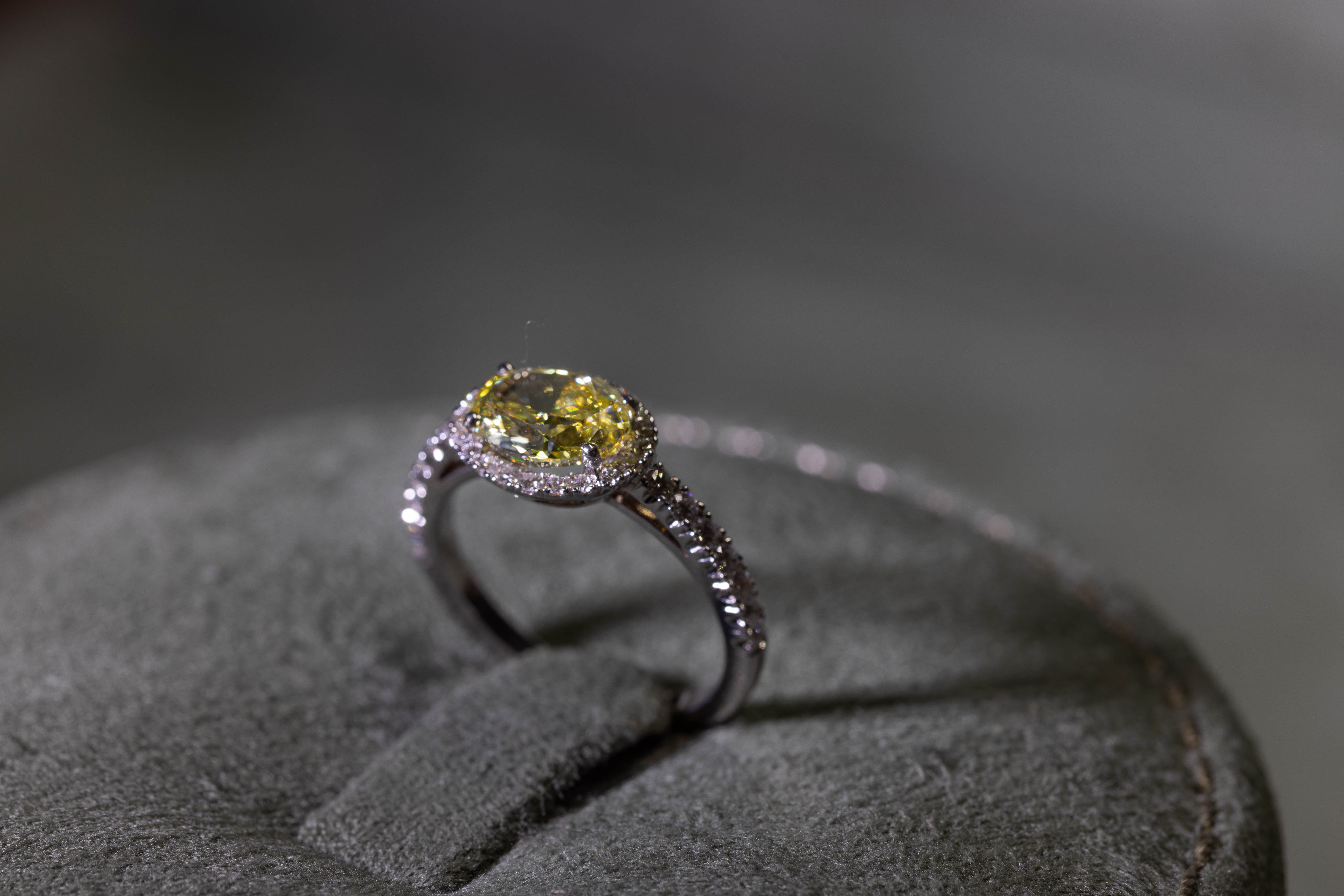Yellow stone ring displayed on a jewellery cushion